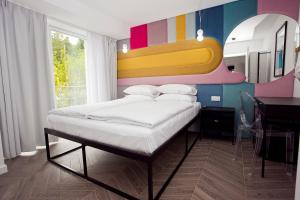 维斯瓦Willowa NO. 5 APARTAMENTS的一间卧室配有一张带彩色墙壁的床