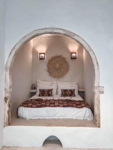 乌姆苏克Dar Naël的一间卧室设有一张带拱形天花板的床