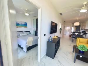蓬塔卡纳Cana Rock Star, Apartamento Lujo Vista Golf Infinity Pool A-410的一间卧室设有一张床和一间客厅。