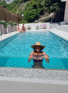 卡拉古诺内尼图诺酒店的戴帽子的女人在游泳池里