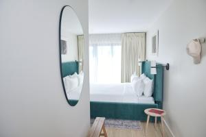 格林波特Hotel Moraine的酒店客房,配有床和镜子