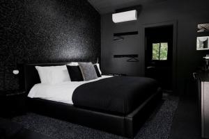 腓尼基The Norsdale plus CMYK Motel on 10 acres in Phoenicia的一间黑色卧室,配有床和窗户
