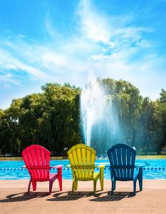 滨湖尼亚加拉Vine Ridge Resort - Cottages的喷泉前有三把五彩缤纷的椅子
