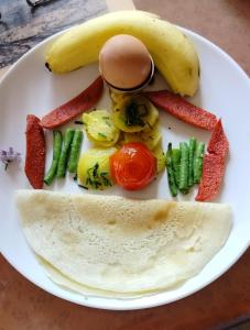 PanaotiCOMMUNITY HOLIDAY INN的含有鸡蛋和蔬菜的食品盘