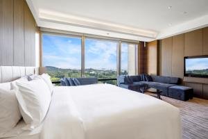 南通南通滨江洲际酒店-一览“江”“山”的卧室设有白色的床和大窗户
