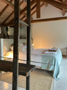 吉马良斯Villa Margaridi的一间卧室配有一张床和一张玻璃桌