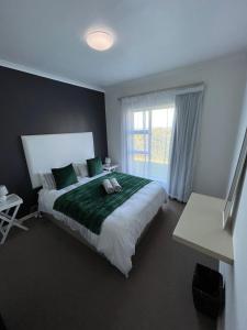普利登堡湾X3 on Goose with Sea View的一间卧室设有一张大床和一个窗户。