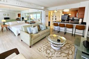 檀香山Ilikai Hotel Condo with Kitchen and Ocean View的一个带床和厨房的大客厅