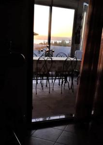 卡拉赛达casa vacanze calasetta的透过门可欣赏到桌椅的景色