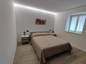 OspedalettoCasa Venere的白色的卧室设有床和窗户
