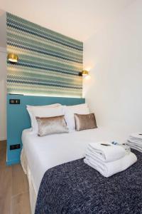 巴黎Résidence Beaugrenelle - Tour Eiffel 1的一间卧室配有一张白色大床和蓝色床头板