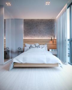 伊塔佩马I Am Design Hotel Itapema by Hotelaria Brasil的卧室设有一张白色大床和大窗户