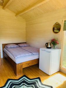 珀尔瓦Orupõhja kämpingud ja telkimisala的木制客房内的一间卧室,配有一张床