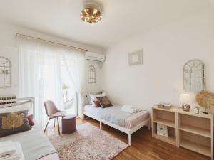 瓦里Varkiza Sea View Apartment - Free Parking的一间卧室配有一张床、一张桌子和一把椅子