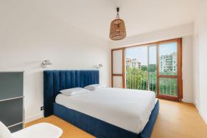 比亚里茨Sixties 64 2 bedrooms apartment with a balcony and parking in Biarritz的一间卧室设有一张床和一个大窗户