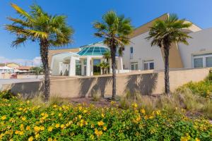 卡奥莱玛尔高尔夫酒店的前面有棕榈树的房子