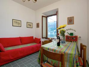 斯特雷萨Enticing Apartment in Stresa with Balcony Lake Views的客厅配有红色的沙发和桌子