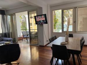 利马索尔SEA VIEW AMATHUS LUXURY APT的客厅配有桌椅和电视。