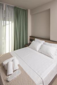 库鲁塔Apanemo Kourouta Luxury Villas的卧室配有一张带白色床单和枕头的大床。