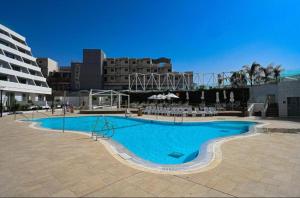 埃拉特Beach side -Luxury sea View Amazing pool Eilat的大楼前的大型蓝色游泳池