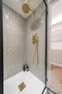 斯托昂泽沃尔德Luxe Contemporary Cotswold Pad - Heart of Stow的浴室设有灰色瓷砖淋浴。
