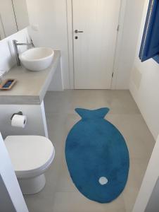 伊奥斯乔拉Luxury studio on the beach的浴室铺有蓝色地毯。
