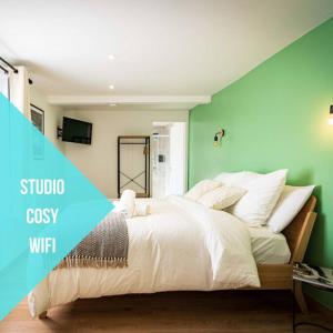 圣康坦L'Albatros 005 - Hypercentre * Cosy * Wifi的一间卧室配有一张白色的床和绿色的墙壁