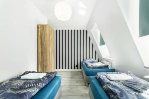 弗罗茨瓦夫VICE CITY Hostel的带楼梯的客房内的2张蓝色床