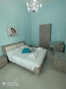 切萨雷奥港Paradise Beach的一间卧室配有一张大床和一个吊灯。