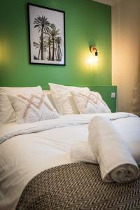 圣康坦L'Albatros 001 - Hypercentre * Cosy * Wifi的一间卧室配有一张白色的床和绿色的墙壁