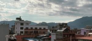 加德满都Nepalaya Home Hostel的享有拥有建筑和山脉的城市美景