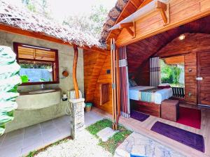 锡吉里亚Palmyra Nature Resort Sigiriya的客房设有床、浴缸和水槽