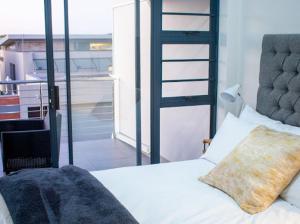 HumewoodSapphire Seas Beach Apartment的一间卧室设有一张床,享有阳台的景色