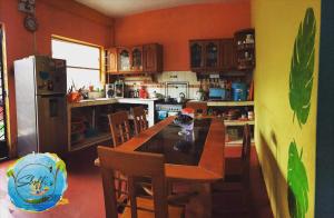 塔拉波托Shoffi's House Backpackers的厨房配有桌椅和冰箱。
