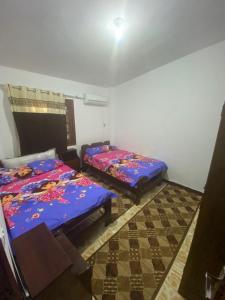 阿里什شالية مفروش قرية سما العريش的一间设有两张床的客房,位于一个设有 ⁇ 板的楼层