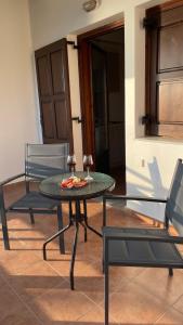 卡拉内拉Anemos Pelion Seaview的一张桌子,两把椅子,一张桌子,上面有比萨饼