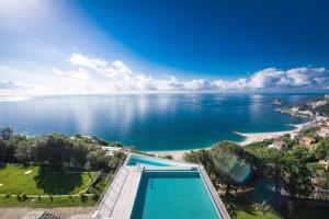 贝尔杰吉Dominio Mare Resort & SPA的海洋和游泳池的空中景致
