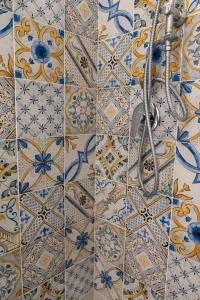 卡普里Casa Rubina的浴室的墙壁上铺有蓝色和白色的瓷砖。
