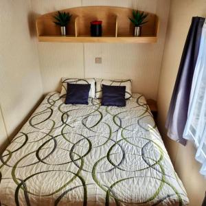 Mobilný domček na brehu Liptovskej Mary的一间卧室配有一张带两个蓝色枕头的床