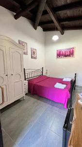 马里内拉Vela Blu的一间卧室配有一张带粉红色床单的大床