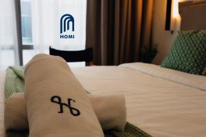 哥打京那巴鲁Homi Oasis 和逸绿洲的一间酒店客房内的一张床位