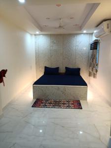 BrahmapurHotel HCB (Hemo Chandra Bhawan)的卧室配有蓝色的床和地毯。