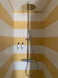 GhigoHotel SALEI的浴室设有黄色和橙色瓷砖,配有淋浴。