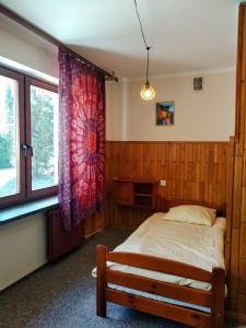韦特利纳Bieszczadzka Legenda的一间卧室设有一张床和一个窗口