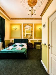 布加勒斯特Hotel Boutique Casa Vermont的一间卧室配有绿色的床和镜子