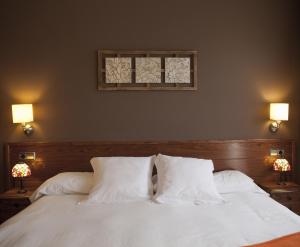 BotHotel & Spa Can Josep的卧室配有白色的床和2个枕头