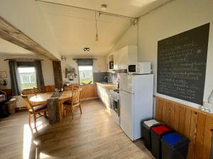 米湖Slow Travel Mývatn - Óli's Homestay-Private house v的厨房配有桌子和白色冰箱。