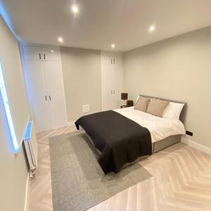 伦敦Luxury 2 bed 1 bath in Central London by Graceful Apartments的一间卧室配有一张大床和黑色毯子