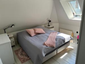 斯塔德Villa Brigitta, havsnära boende mittemot Klostret i Ystad centrum的一间卧室配有一张带两个粉红色枕头的床