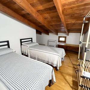 阿尔盖罗Casa del Mate的配有木天花板的客房设有两张床。